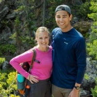 Devon O'Brien and his significant other other posing for a photo while on a hike in the woods.