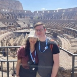 Portrait of Emily Fahr, OBGYN resident, with her partner in front of the Roman Coliseum. 