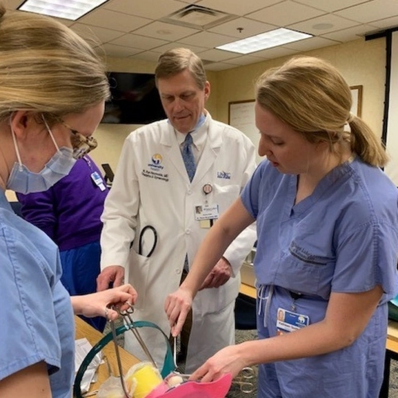 OBGYN faculty and residents practice a procedure in the simulation lab. 