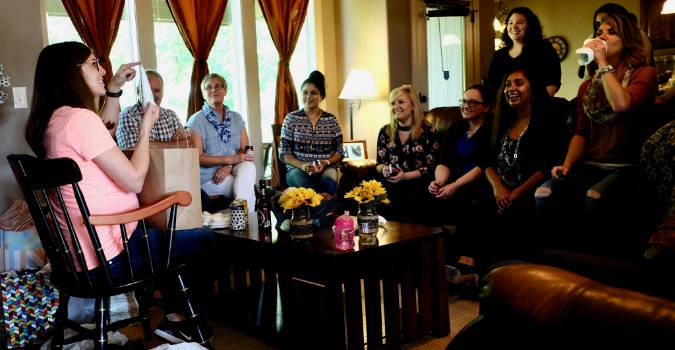 OBGYN residents celebrating a baby shower for one of the residents at somebody's house.