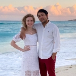 Portrait of Janna Ochoa, OBGYN resident, with her husband on the beach.