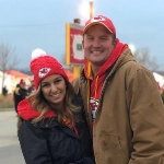 Portrait of Samantha Rios, OBGYN resident, with her partner at a Chiefs game.