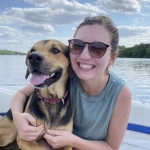 Portrait of Allison Tigner, OBGYN resident, with her dog on a boat.