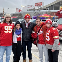 Zachary Alholm with posing for a photo with his family while tailgating before a Chiefs game at Arrowhead stadium. 