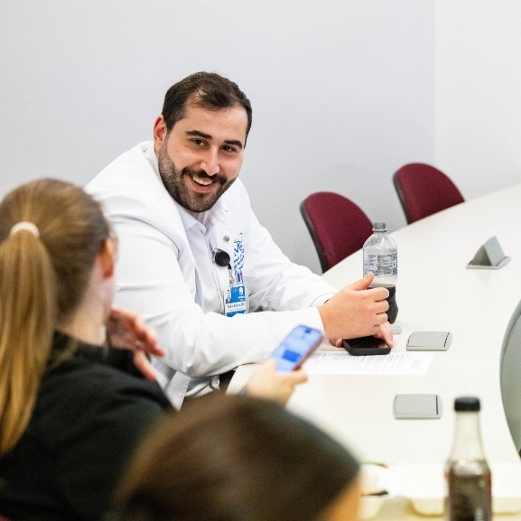 School of Medicine staff happily talking during a conference.