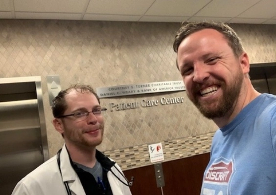 Two School of Medicine residents smile while taking a selfie inside a hospital.