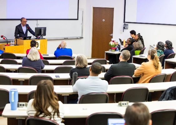 Shannon Endowed Lectureship guest speaker giving a lecture to a crowd in an auditorium. 