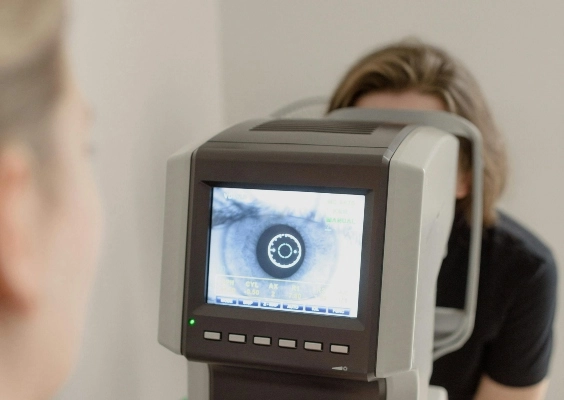 Closeup of a doctor looking at a patients eye through an autorefractor.