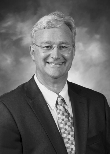 Portrait of Dr. Mark Bernhardt dressed in a suit and tie.