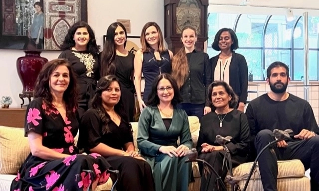 Pathology residents posing for a graduation photo in someone's living room.