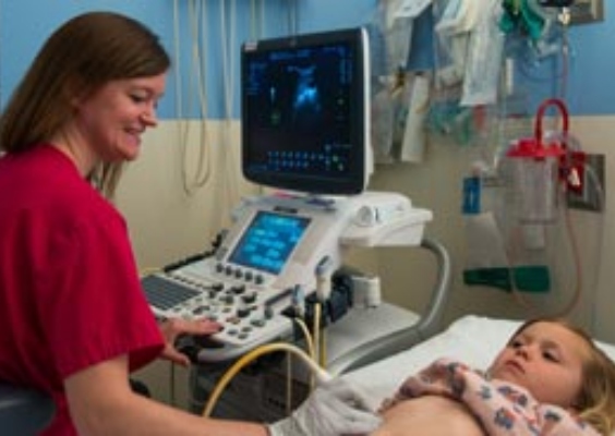 A radiologist conducts an ultrasound.