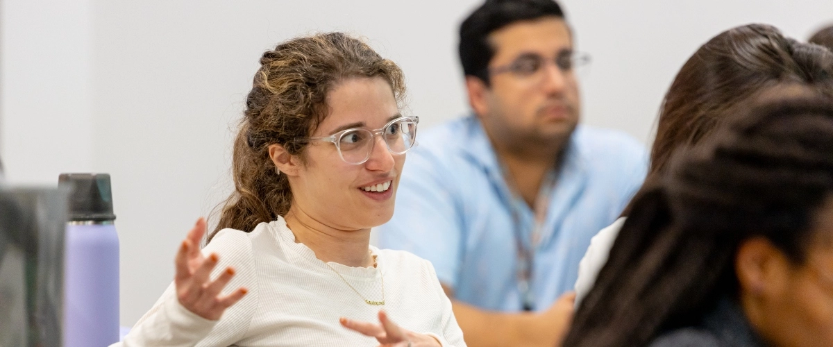 A surgery resident asks a question during a lecture.