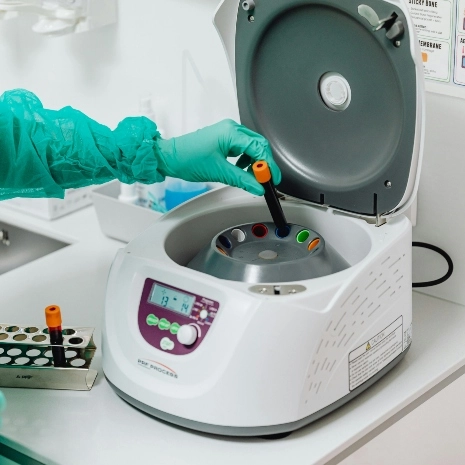 Researcher using a lab centrifuge.