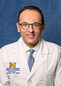 Portrait of Dr. Sanjay Kishor Saint, M.D., MPH, in his University of Michigan physician's coat.