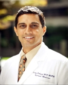 Portrait of Dr. Niraj Sehgal, M.D., MPH in his physician's coat.