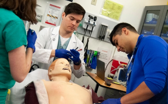 Medical students and faculty working together in the simulation lab.